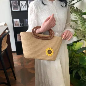 Stylish woven baskets with sunflower accents and bamboo handles.